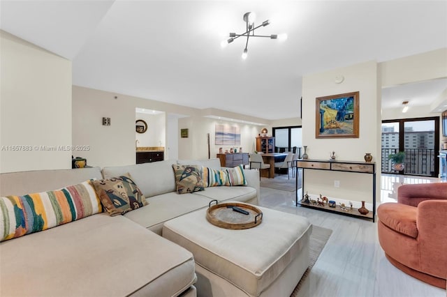 living room featuring light hardwood / wood-style flooring, plenty of natural light, and a chandelier