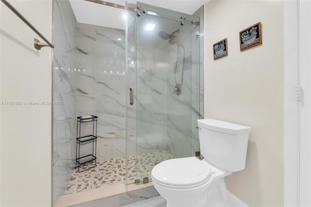 bathroom with an enclosed shower and toilet