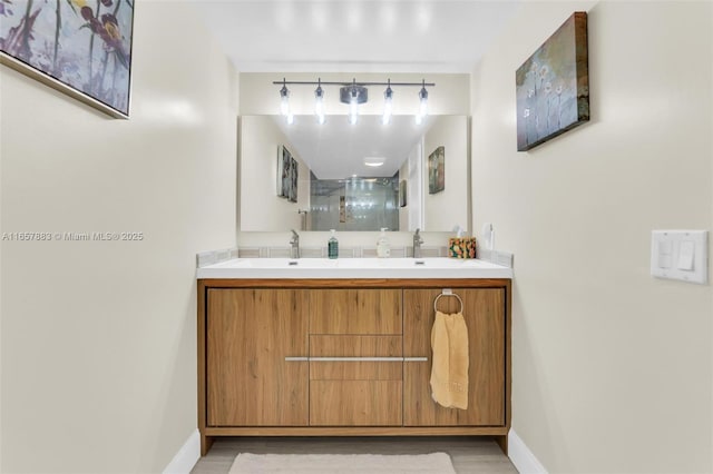 bathroom featuring vanity and a shower with shower door