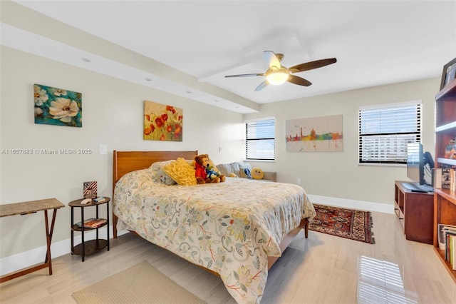 bedroom with multiple windows, ceiling fan, and light hardwood / wood-style flooring