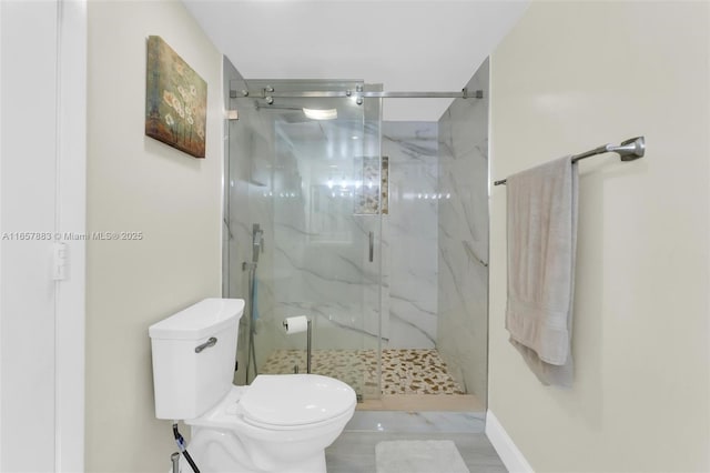 bathroom featuring toilet and an enclosed shower