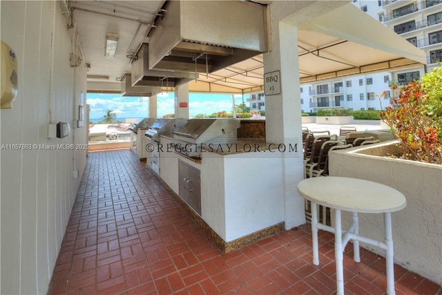 view of patio / terrace featuring an outdoor kitchen and a grill