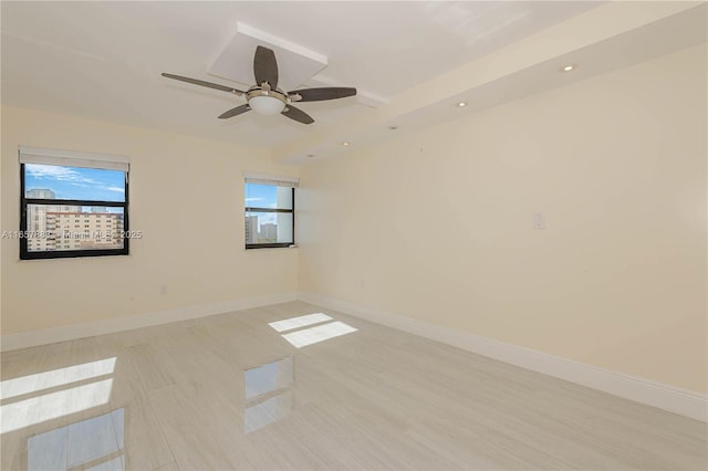 spare room with light hardwood / wood-style flooring and ceiling fan