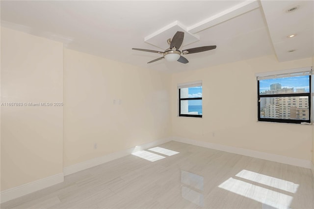 spare room featuring ceiling fan and plenty of natural light