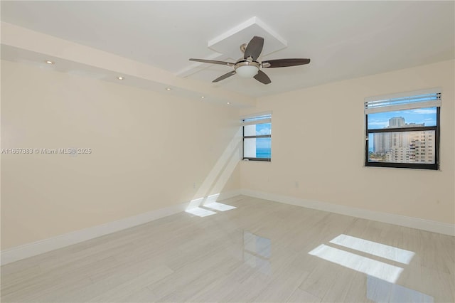 unfurnished room featuring ceiling fan and a healthy amount of sunlight