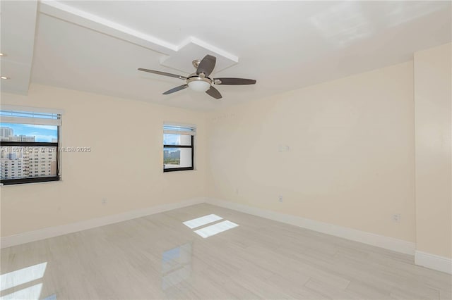 spare room featuring ceiling fan and light hardwood / wood-style floors