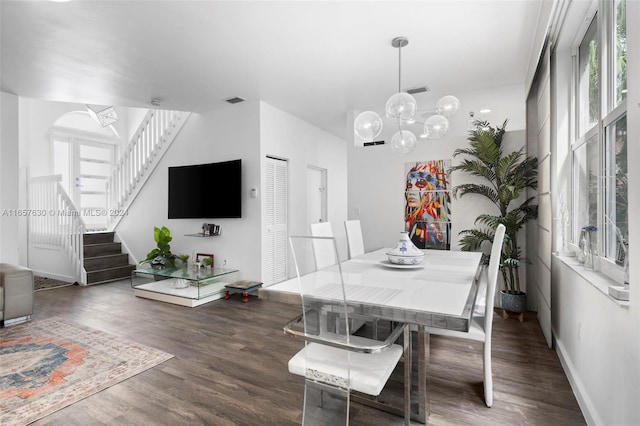 dining room featuring dark hardwood / wood-style floors and an inviting chandelier