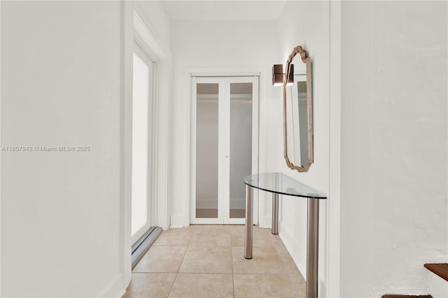 hall with light tile patterned floors