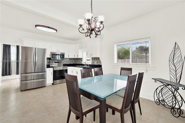 dining space with a chandelier and light tile patterned floors