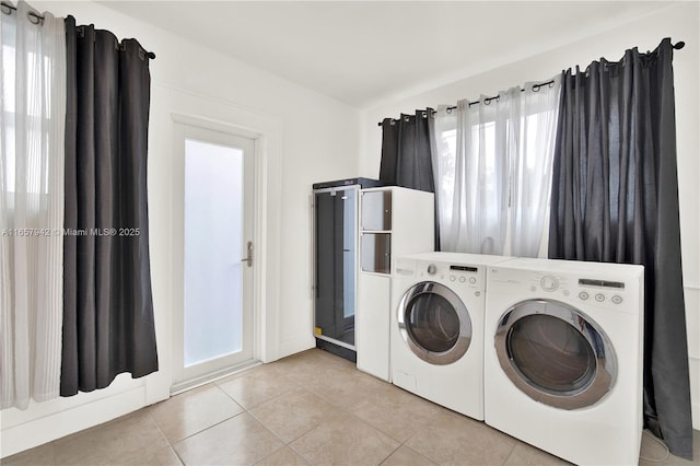 laundry room featuring light tile patterned floors and independent washer and dryer