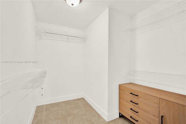 walk in closet featuring light tile patterned floors