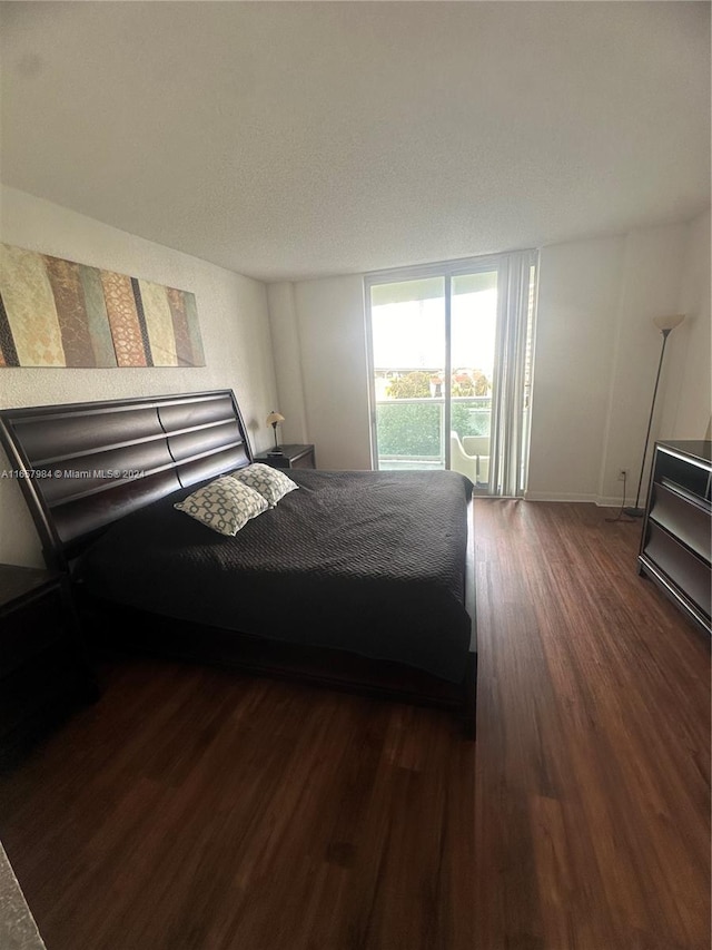 bedroom with dark hardwood / wood-style flooring