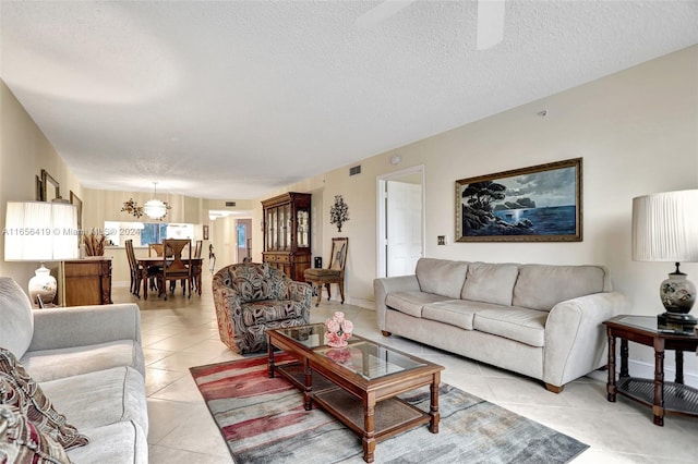 tiled living room featuring a textured ceiling