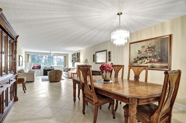 dining area featuring a textured ceiling, light tile patterned floors, and a notable chandelier