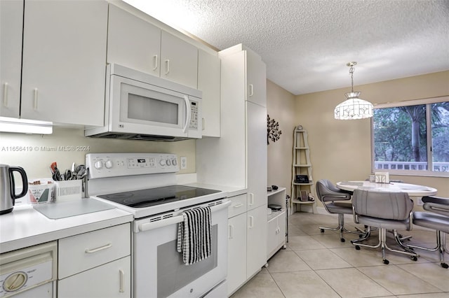 kitchen featuring white cabinetry, a textured ceiling, light tile patterned floors, hanging light fixtures, and white appliances