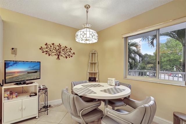 dining room with a textured ceiling and light tile patterned floors