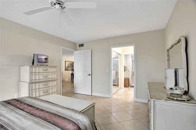 tiled bedroom featuring ceiling fan and a textured ceiling