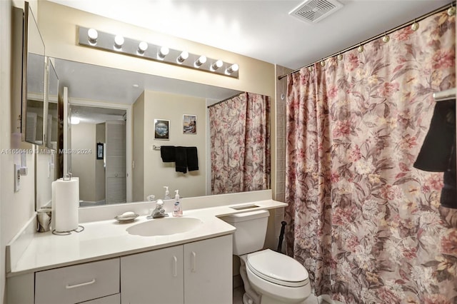 bathroom featuring vanity, toilet, and a shower with curtain