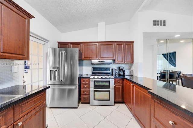 kitchen featuring lofted ceiling, stainless steel appliances, extractor fan, visible vents, and decorative backsplash