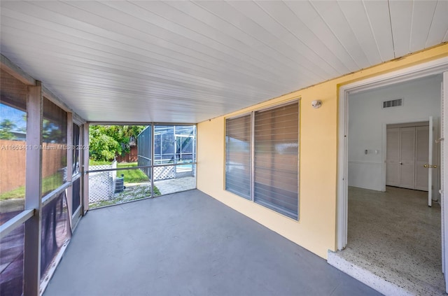 unfurnished sunroom featuring visible vents and a healthy amount of sunlight
