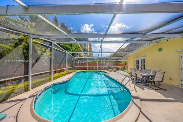 view of pool featuring a fenced in pool, french doors, a fenced backyard, a lanai, and a patio area