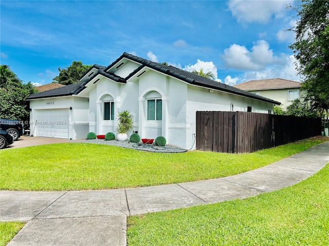 view of front of home featuring a garage and a front lawn