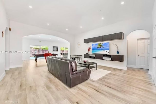 living room with pool table and light hardwood / wood-style floors