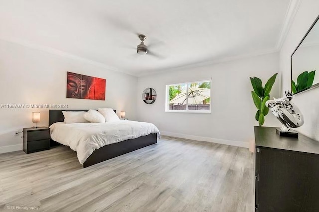 bedroom featuring ornamental molding, ceiling fan, and light hardwood / wood-style floors