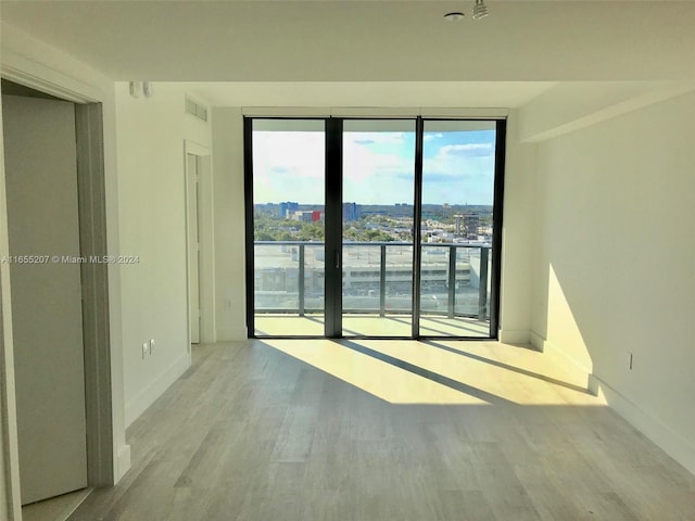 unfurnished room with light wood-type flooring