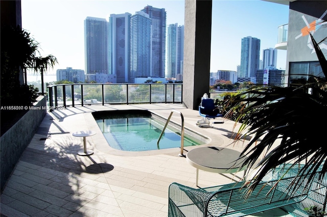 view of swimming pool featuring a community hot tub