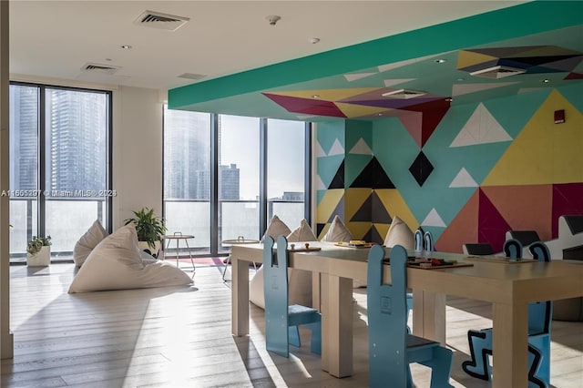 dining area with expansive windows and light hardwood / wood-style floors