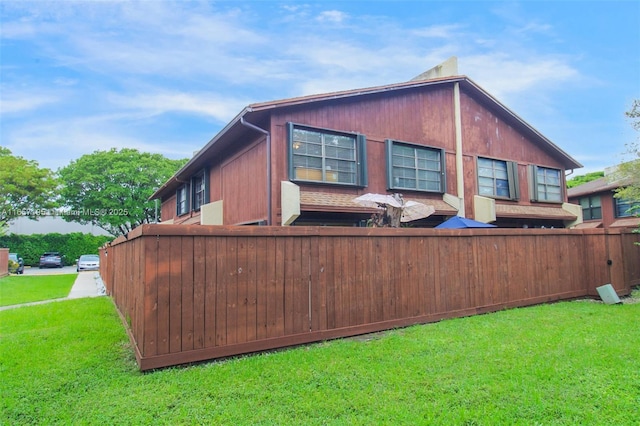 view of property exterior with a lawn