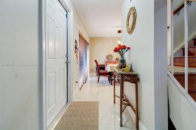 hall with light tile patterned floors