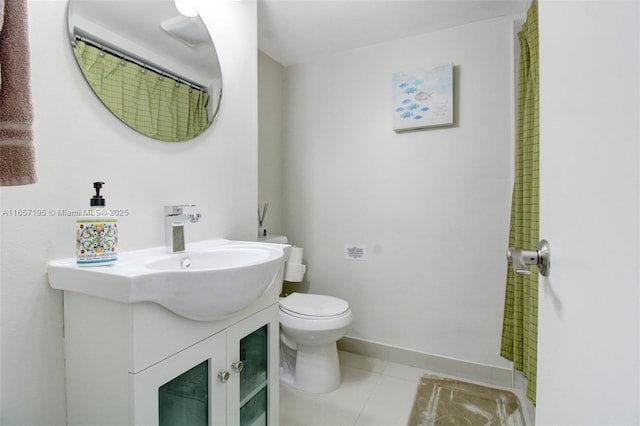 bathroom featuring toilet, vanity, and tile patterned floors