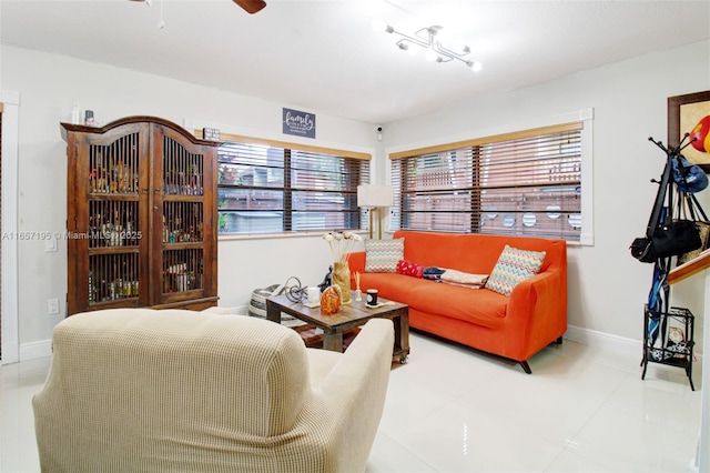 living room featuring ceiling fan and tile patterned flooring