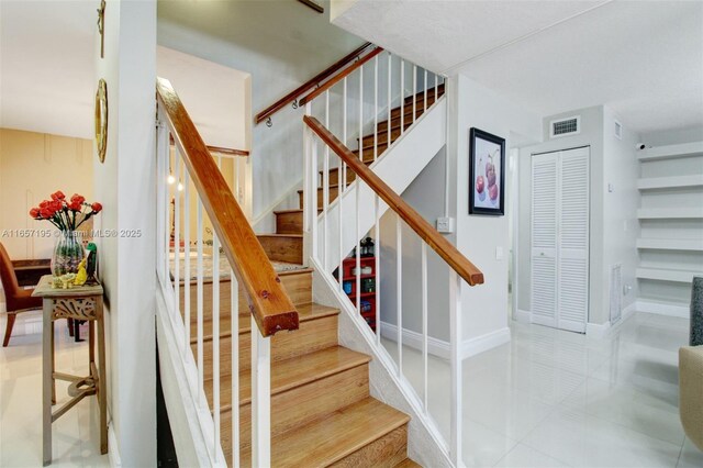 stairs featuring tile patterned floors