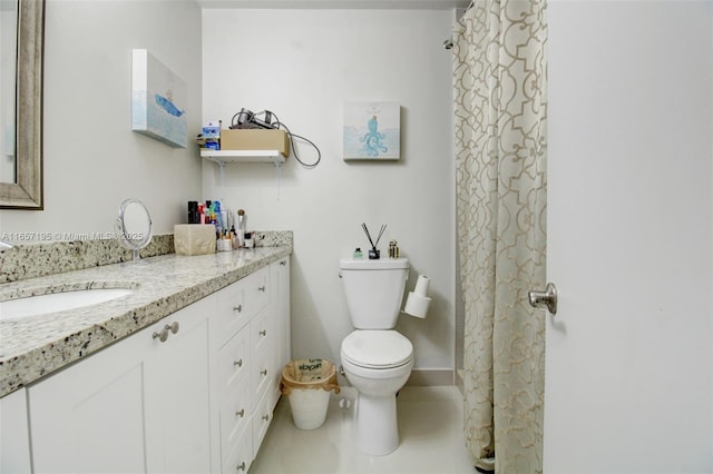 bathroom featuring toilet, vanity, and tile patterned flooring