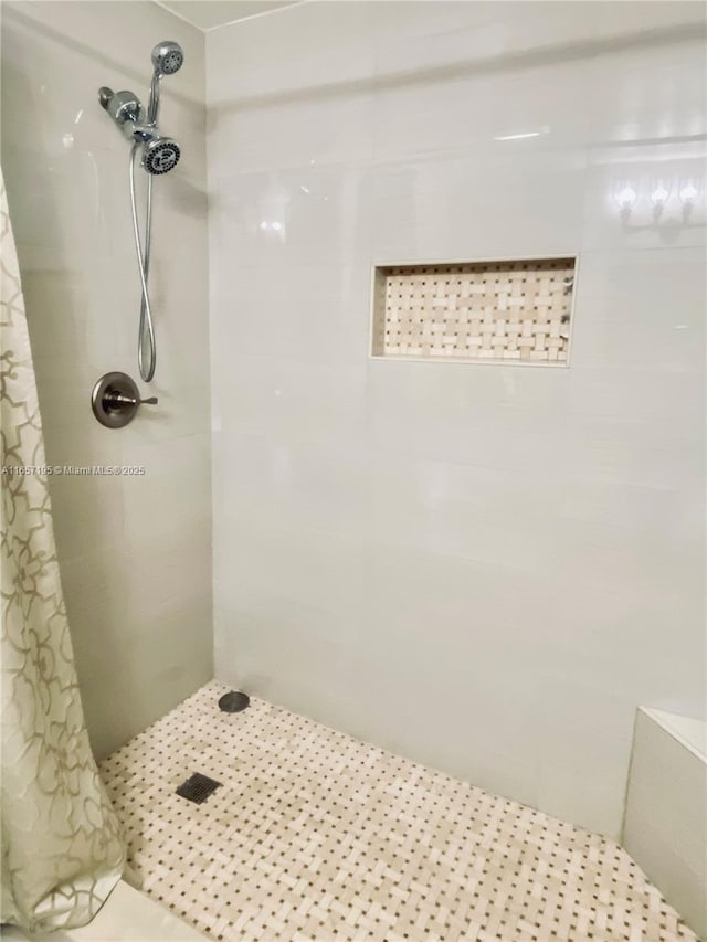 bathroom featuring curtained shower and tile patterned flooring