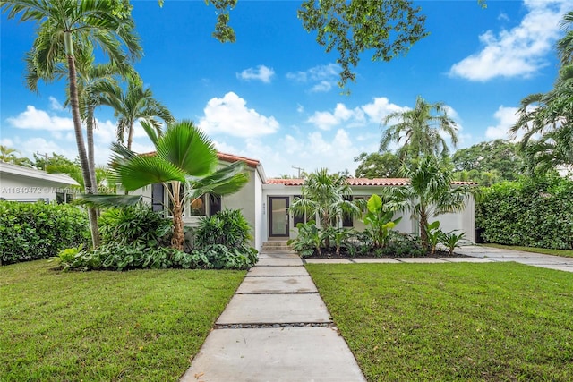 mediterranean / spanish home featuring a front yard