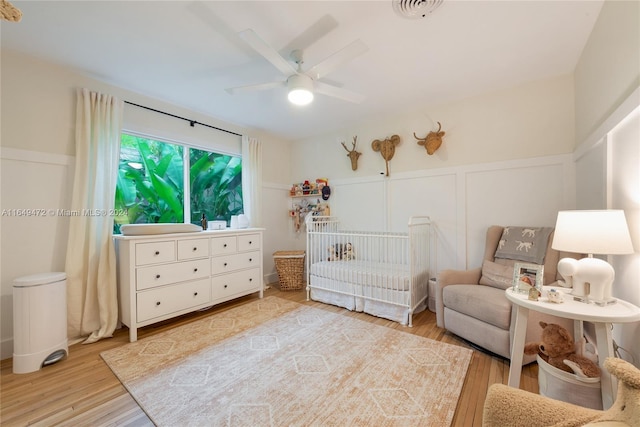 sitting room featuring ceiling fan and light hardwood / wood-style floors