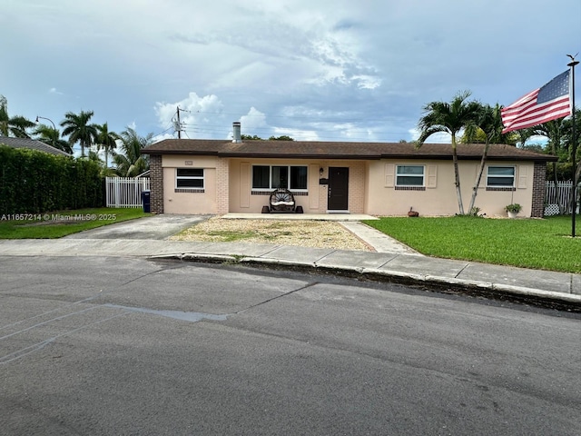 ranch-style home with a front lawn