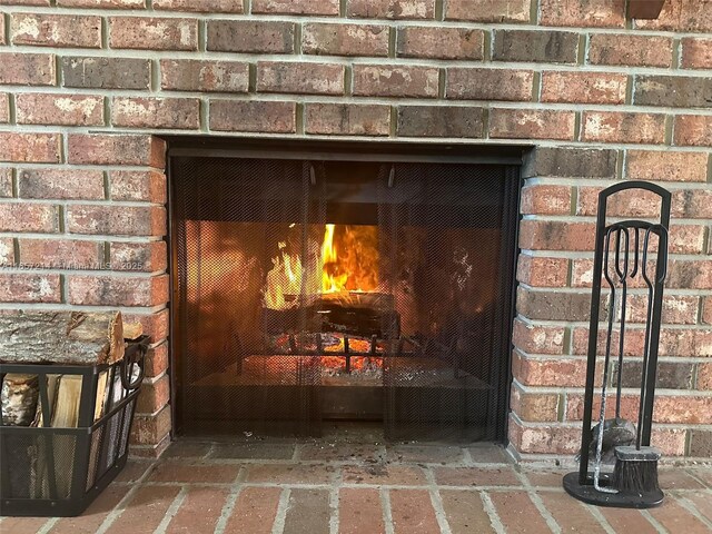 interior details with a brick fireplace