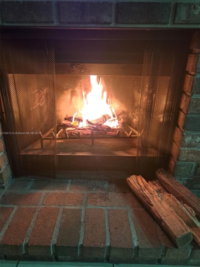 interior details featuring a brick fireplace