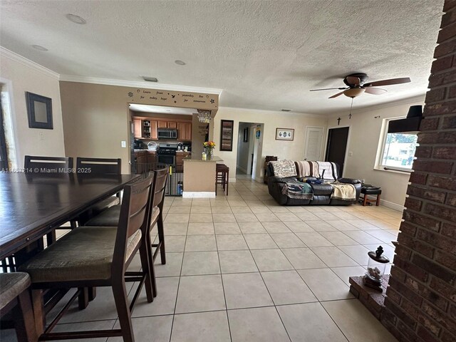 kitchen featuring light tile patterned floors, appliances with stainless steel finishes, light stone counters, kitchen peninsula, and beverage cooler