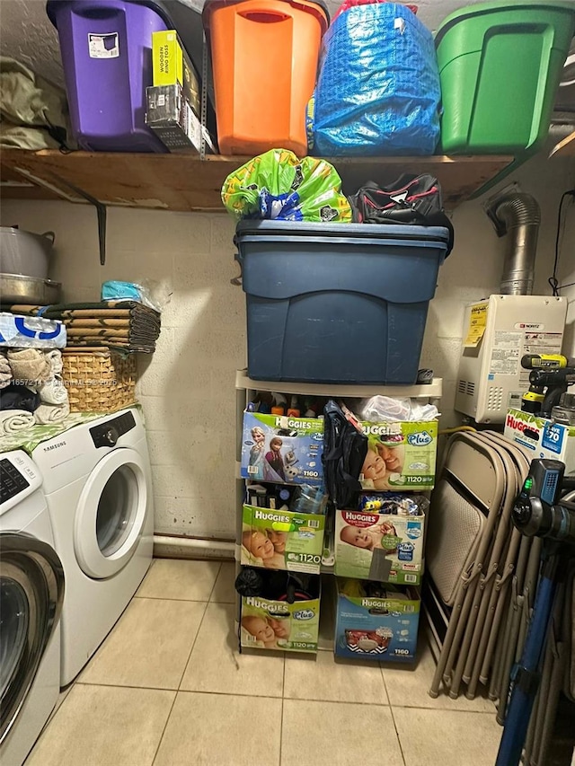 washroom featuring light tile patterned flooring and washer and clothes dryer