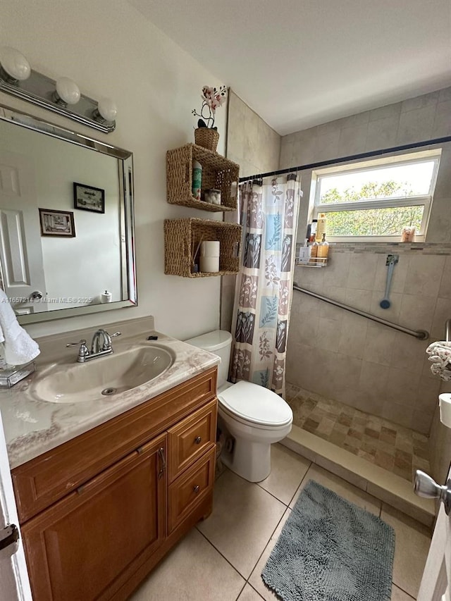 bathroom with toilet, vanity, tile patterned flooring, and a shower with shower curtain