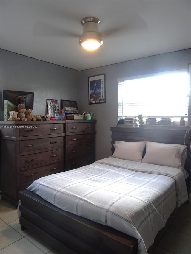 tiled bedroom with ceiling fan