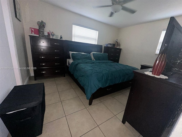 tiled bedroom featuring ceiling fan