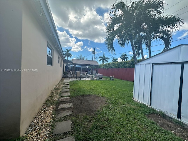 view of yard with a storage shed, a patio area, and a gazebo