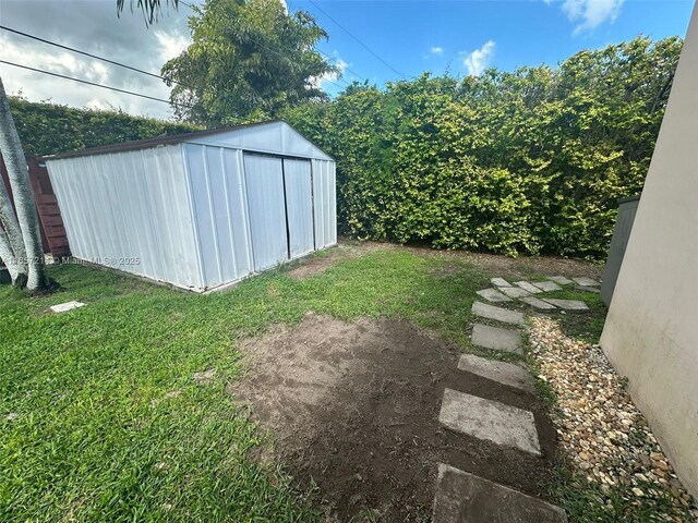 exterior space featuring a gazebo, a lawn, a patio, and a storage unit